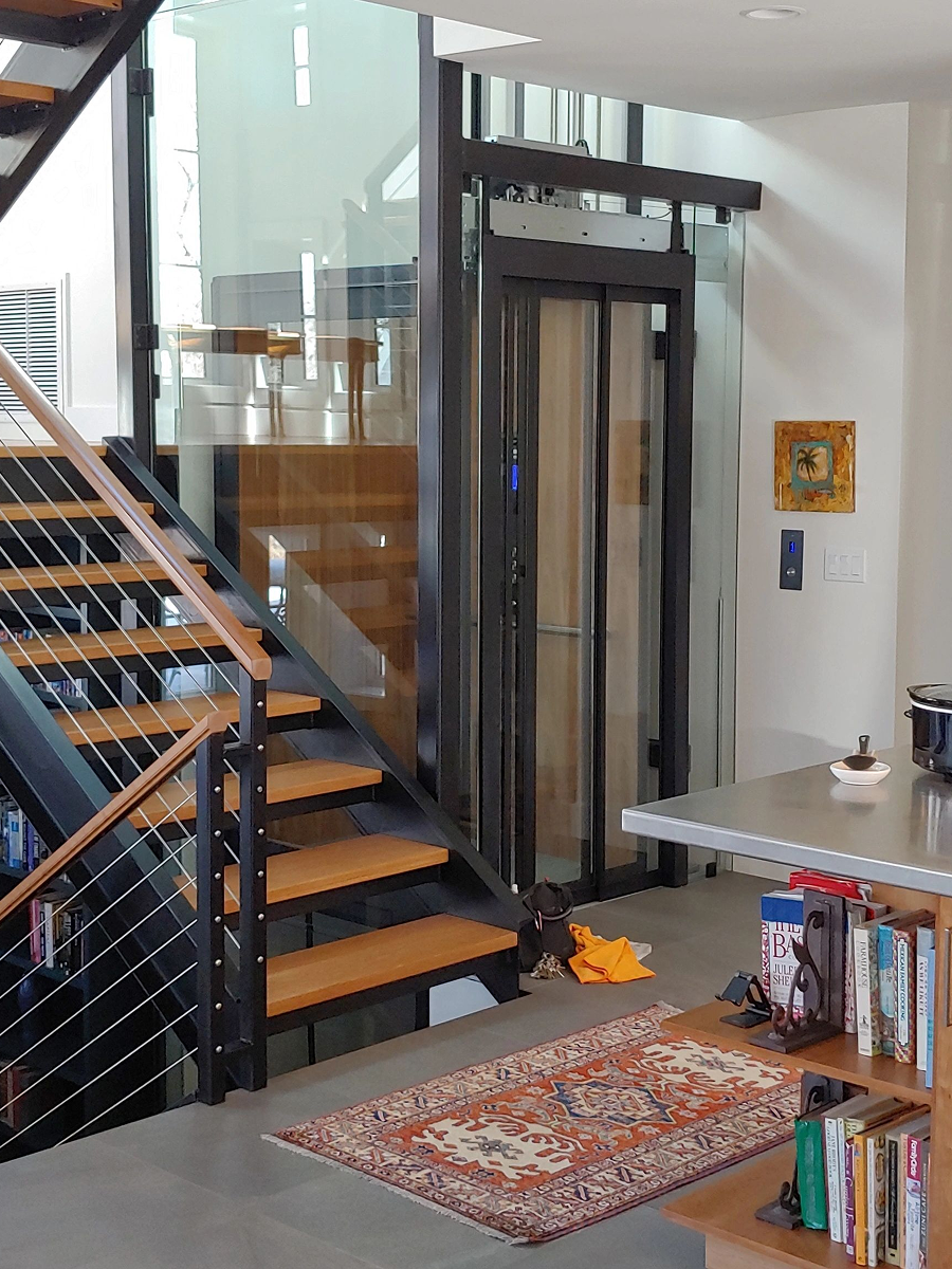 Wooden staircase beside glass elevator